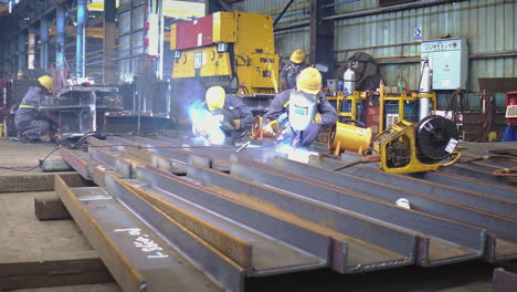 Welders-Working-At-Metal-Fabrication-Making-Structural-Channel-Beam