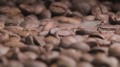 Close-up-slow-motion-shot-of-roasting-coffee-beans-as-smoke-starts-to-appear-bringing-out-the-beautiful-aroma-and-flavours
