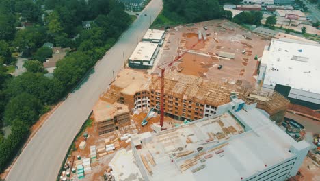 Epic-drone-footage-of-an-active-construction-site-with-oncoming-traffic-nearby