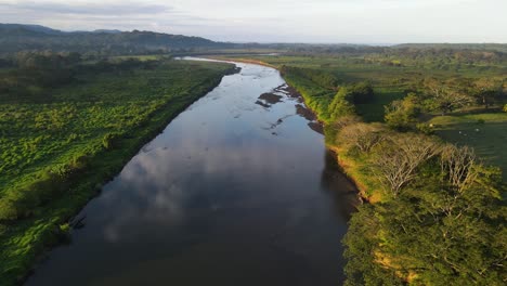 Drone-flying-over-a-river-towards-the-horizon
