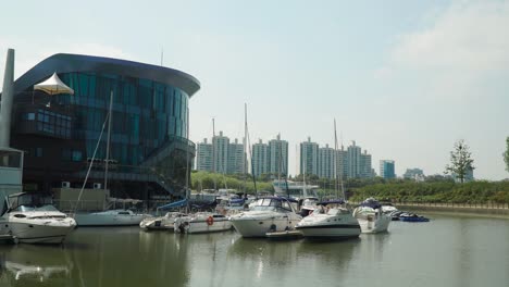 The-Seoul-Marina-Club-with-Many-Yachts,-Sailboats,-Speedboats-moored-or-anchored-near-the-pier-at-Yeouido-Island,-South-Korea