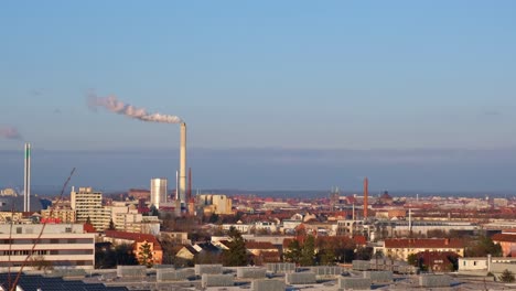 Skyline-of-industrial-part-of-a-city-with-chimney-of-power-plant-producing-smoke