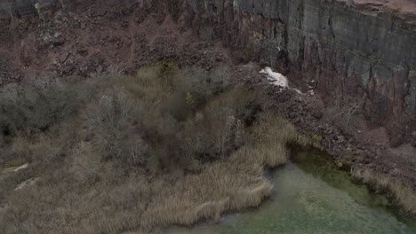 Aerial-view-drone-flight-on-some-rocks-pan-down-in-Kinnekulle-Sweden