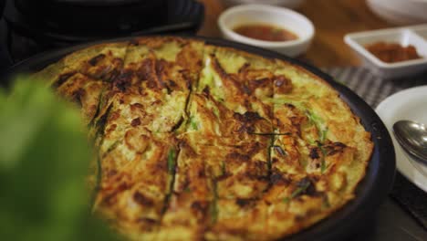 Buchimgae---Plate-Of-Korean-Pancake-Served-On-Table-In-A-Korean-Restaurant
