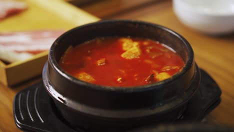 Kimchi-Stew---Kimchi-jjigae-Served-In-Ttukbaegi-In-A-Korean-Restaurant
