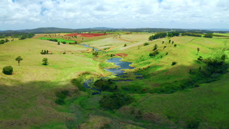Paisaje-Tranquilo-Con-Campos-Verdes-Y-Estanque-En-Las-Mesetas-De-Atherton,-Queensland,-Australia---Toma-Aérea-De-Drones