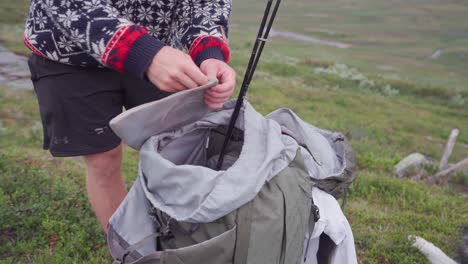 Hiker-Organizing-His-Things-On-The-Backpack---Man-Packing-His-Bag