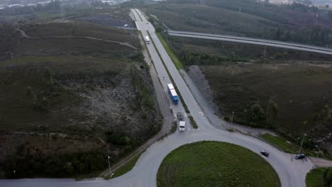 Cars-And-Semi-trailer-Trucks-Driving-At-Roundabout-At-Early-Morning-In-Portugal