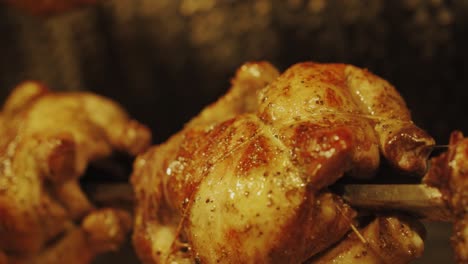 Golden-Brown-Rotisserie-Chicken-Roasting-Beautifully-In-Oven---close-up-shot