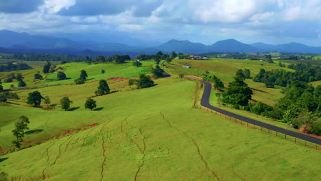 Aerial-View-Of-Idyllic-Country-Road-Against-Cloudy-Sky-In-Atherton-Tablelands,-Queensland,-Australia---drone-shot