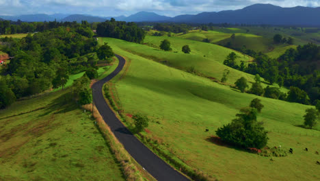 Rolling-Hills-And-Scenic-Road-In-Atherton-Tablelands,-Queensland,-Australia---aerial-drone-shot