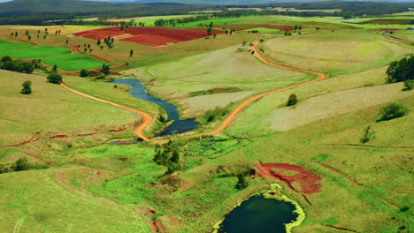Drone-Flight-Over-Creeks-And-Colorful-Fields-In-Atherton-Tablelands,-Queensland,-Australia