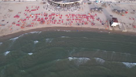 Aerial-view-the-Bugrashov-Beach,-sunrise-in-Tel-Aviv,-Israel---tilt,-drone-shot