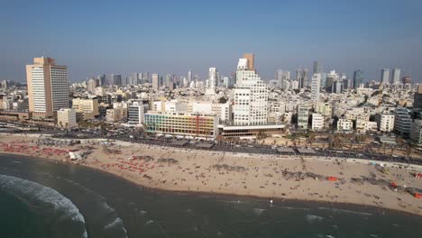 Aerial-view-overlooking-beaches-and-the-cityscape-of-Tel-Aviv,-in-sunny-Israel---pan,-drone-shot