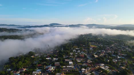 Jarabacoa-aerial-view-during-a-sunrise-over-the-fog,-with-mountains-at-the-back,-cold-weather-in-the-Caribbean,-Dominican-Republic
