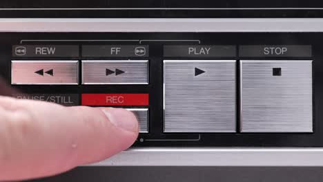 Extreme-close-up-of-buttons-on-an-old-antique-or-vintage-VCR,-Pushing-and-holding-the-Record-button