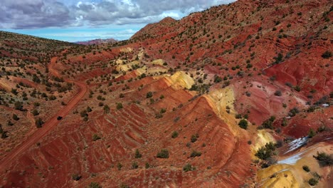 Aerial-view-over-orange-and-yellow-rock-formations-in-vermillion-cliffs,-utah