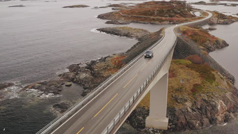 Car-Crossing-Magnificent-Storseisundet-Bridge-On-Atlantic-Ocean-Road,-Norway