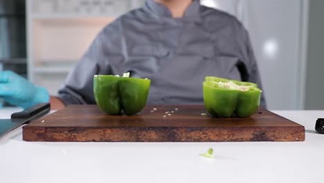 Slow-motion-green-pepper-being-chopped-in-half