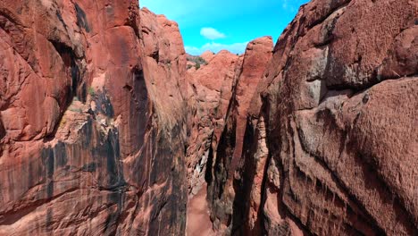 Drone-flying-low-and-backward-inside-slot-canyon
