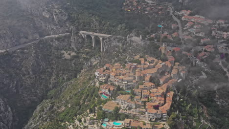 Eze-France-Aerial-v21-cinematic-high-angle-birds-eye-view,-drone-flying-around-hillside-fortified-medieval-village-and-exotic-garden-next-to-moyenne-corniche---July-2021