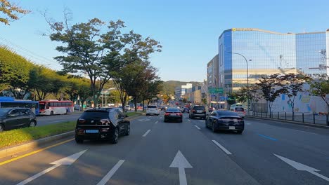 Dirver's-POV---Ambulance-119-car-moving-with-emergency-flashing-beacons-through-heavy-traffic-jam-in-Autumn-Seocho-District,-Seoul