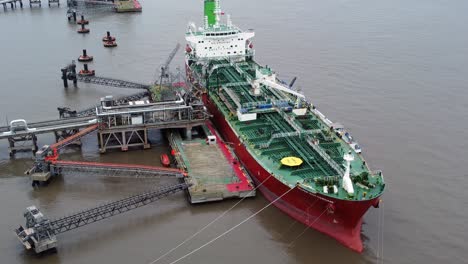 Silver-Rotterdam-oil-petrochemical-shipping-tanker-loading-at-Tranmere-terminal-Liverpool-aerial-left-orbit-reversing-view
