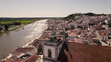 Beautiful-rooftops-of-Alcacer-Do-Sal-town-on-Sado-river-coastline,-aerial-orbit-view