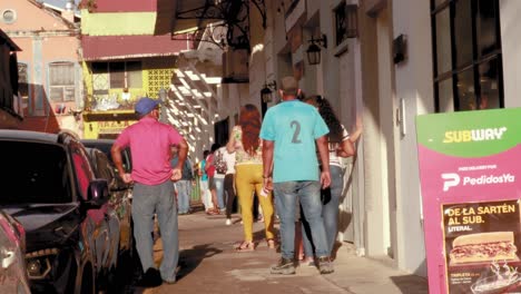 People-waiting-in-a-queue-on-a-sidewalk-to-receive-treatment-at-a-local-medical-Centre,-individuals-getting-restless-as-they-have-been-standing-patiently-for-some-time,-Casco-Viejo,-Panama-City