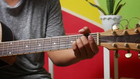 Man's-hand-playing-guitar