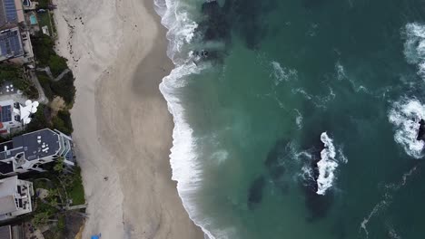 Calm-Waves-Crashing-On-Beach-Shore-by-Luxury-Homes-Beach-Town