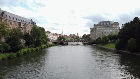 Rhine-River-in-City-Centre-of-Strasbourg-with-Tram-passing-a-Bridge