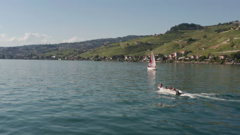 Flying-towards-small-motorboat-driving-over-lake-Geneva