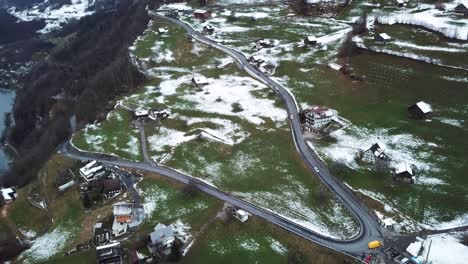 Different-cars-driving-down-a-mountain-road-in-Amden,-Switzerland