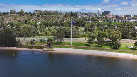Drone-flies-away-from-Aus-flag-flying-in-Perth-Park