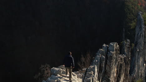 Man-Walking-on-Steep-Rock-Formation,-Seneca-Rocks,-West-Virginia-USA