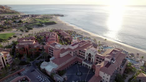 Beautiful-aerial-view-of-a-coastal-resort-and-villa-in-summer-sun,-Cabo-Mexico