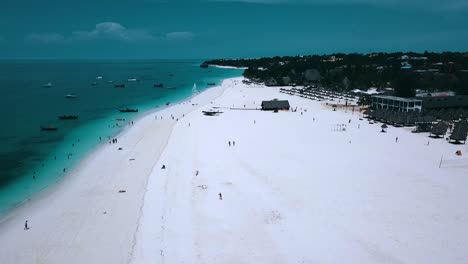 Buttery-soft-aerial-flight-fly-forwards-drone-shot-of-Paradise-dream-white-sand-beach-and-crystal-clear-turquoise-water-on-zanzibar,-africa-2019