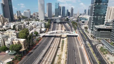 Aerial-view-over-the-empty-highway-in-Tel-Aviv,-Israel,-during-Yom-Kippur-the-Day-of-Atonement---tilt,-drone-shot