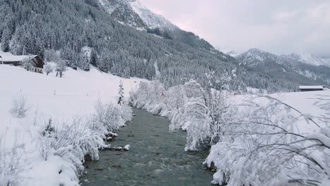 Aerial-shot-of-a-snow-covered-mountain-creek