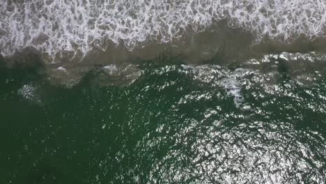 Topdown-Of-Emerald-Ocean-With-Foamy-Waves-At-Summertime