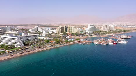 Aerial-footage-of-hotels-and-resorts-Eilat's-coastline,-a-beautiful-city-at-south-Israel-on-the-Red-Sea-shore