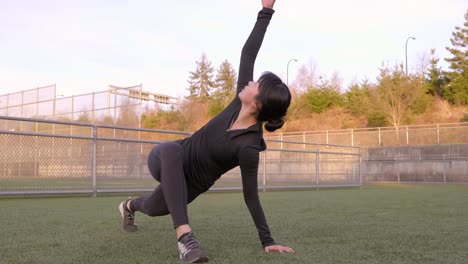 Fitness-woman-performs-twisting-lunge-transitioning-to-lizard-pose