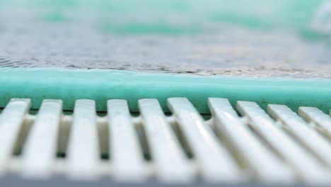 Close-Up-Of-An-Edge-Of-Swimming-Pool-With-White-Drain