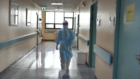 Medic-Wearing-Full-PPE-Walking-In-COVID-19-Hospital-Hallway