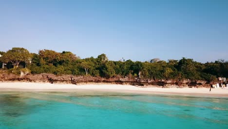 Calmer-aerial-flight-slider-fly-sideways-from-right-to-left-drone-shot-dream-nature-beach-coast-line-turquoise-water-Zanzibar,-africa-tanzania-2019-Cinematic-aerial-filmed-1080,-60p-at-Philipp-Marnitz