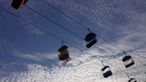A-hanging-gondola-lift-crosses-the-evening-sky-at-amusement-park