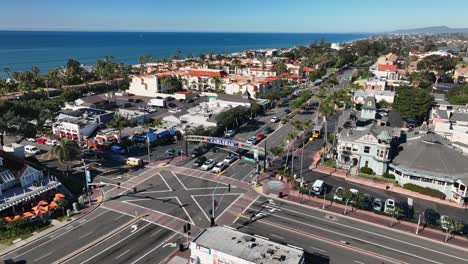 Rotating-drone-view-of-a-pacific-coast-highway-crossing-in-Carlsbad,-California