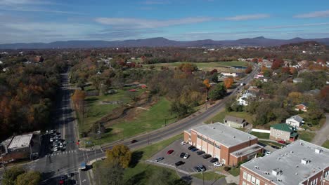 Drone-aerial-view-of-Roanoke-suburbia-in-colorful-autumn-landscape,-Virginia-USA-on-sunny-day