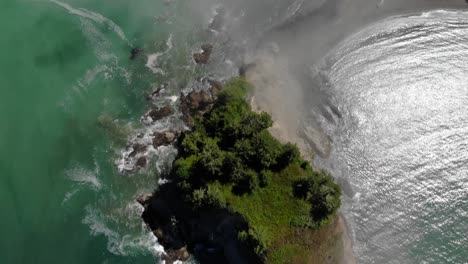 Aerial-top-down-Little-James-Island-in-Pacific-ocean,-wild-green-vegetation-and-pristine-ocean-water-during-sunny-day